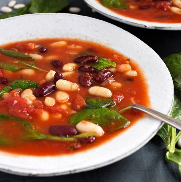 tomato bean soup with spinach in bowls
