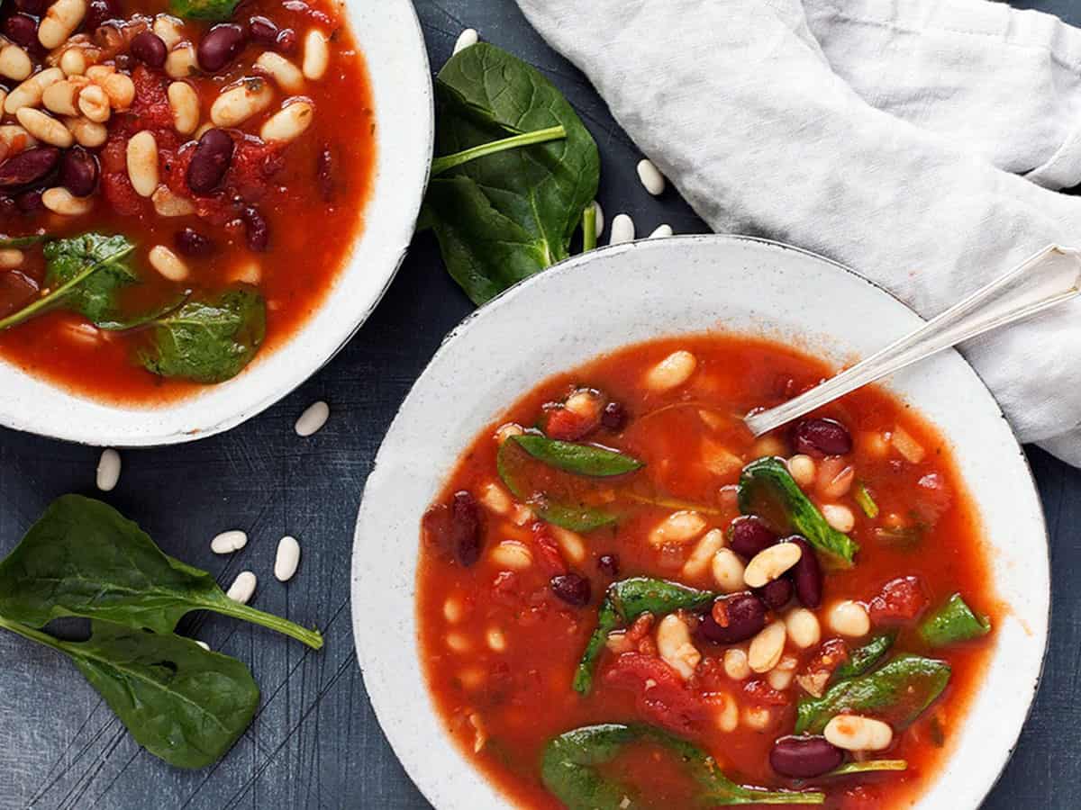 tomato bean soup with spinach in bowls