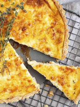 classic quiche lorraine on cooling rack sliced