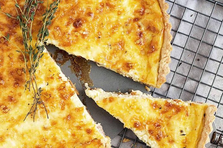 classic quiche lorraine on cooling rack sliced