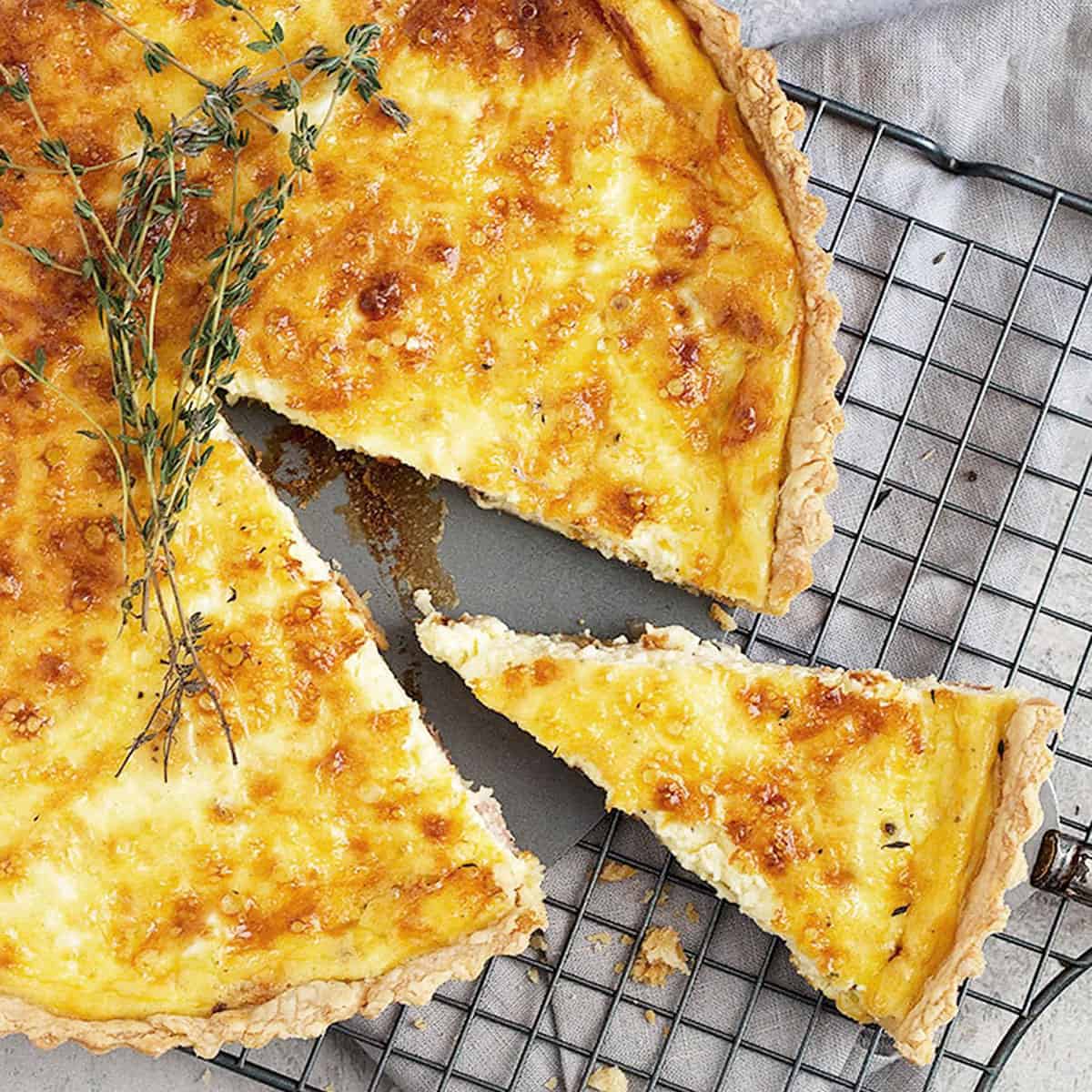 classic quiche lorraine on cooling rack sliced