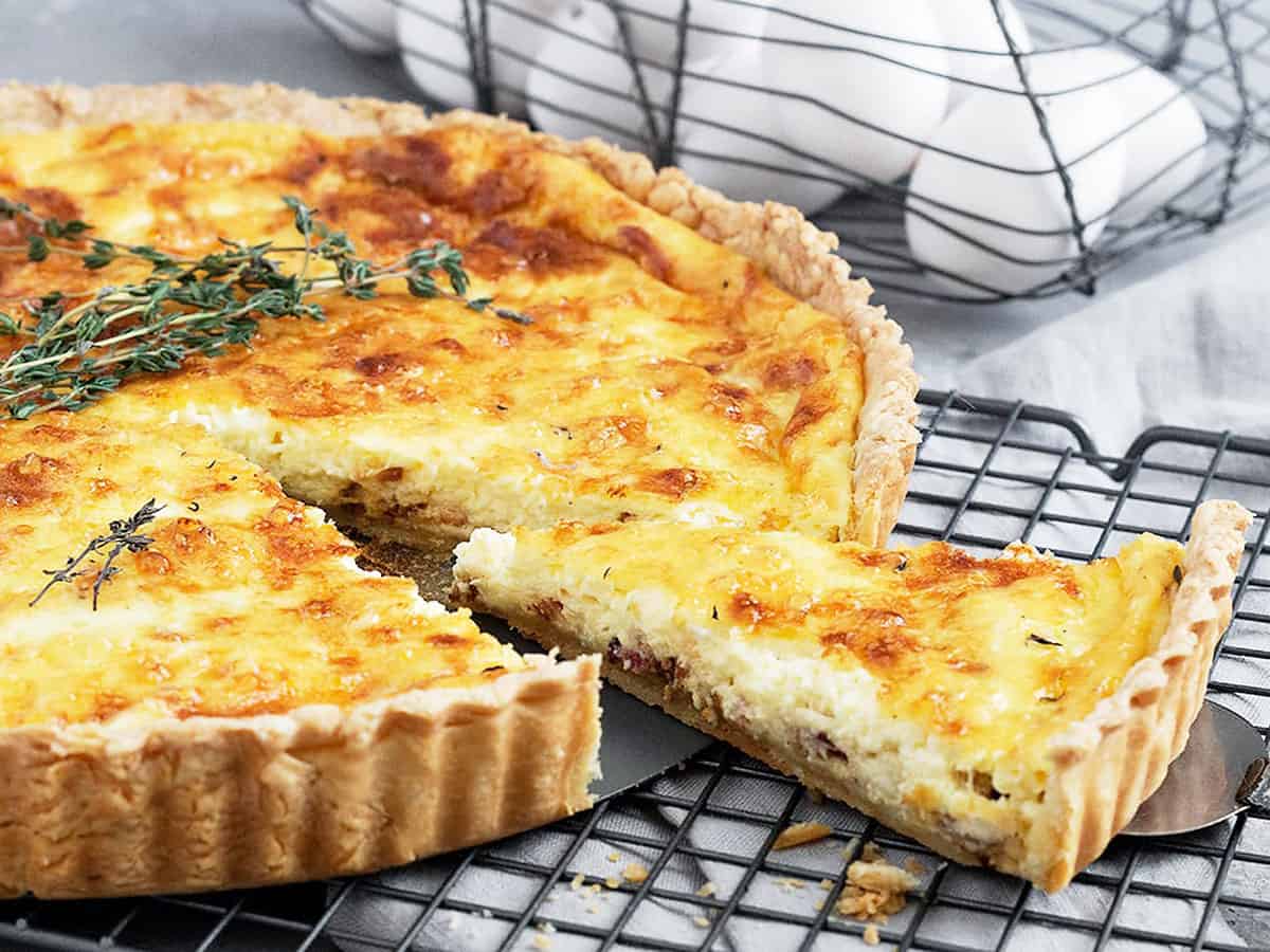 classic quiche lorraine on cooling rack sliced