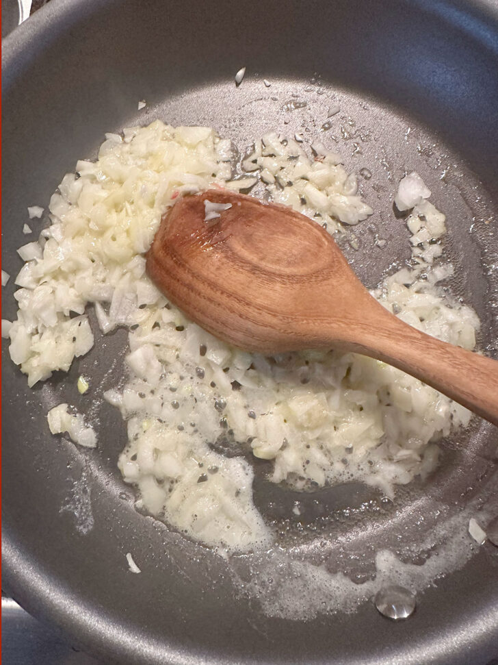 Softening onion in skillet.