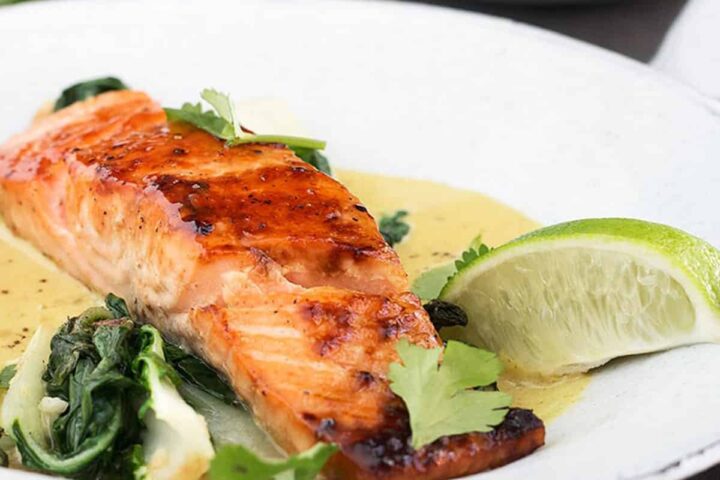 sugar-seared salmon in bowl with coconut lime sauce