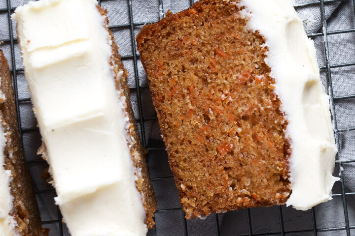 Carrot cake loaf with cream cheese frosting sliced.