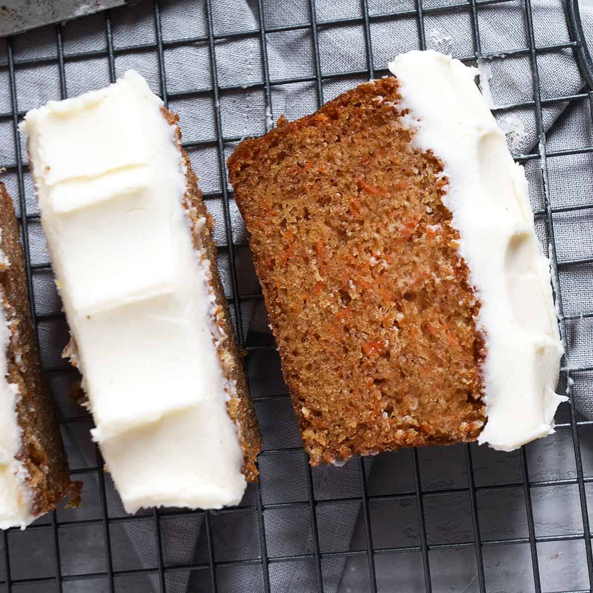 Carrot cake loaf with cream cheese frosting sliced.
