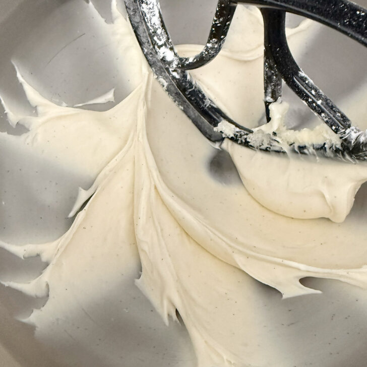 Cream cheese frosting in a mixing bowl after beating.