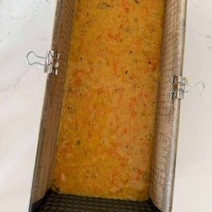Batter added to the parchment-lined loaf pan.