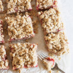 strawberry rhubarb crumble squares on parchment