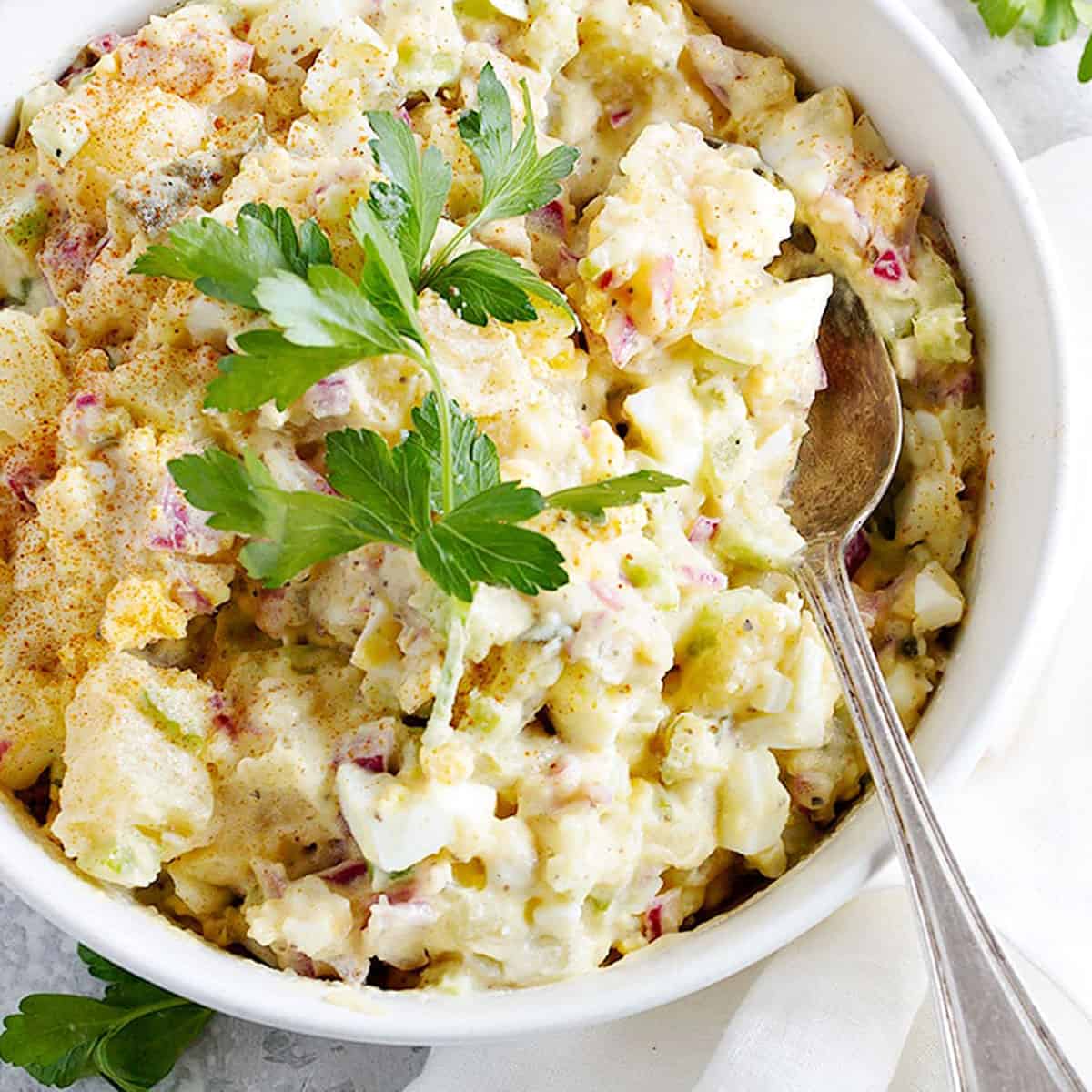 Classic creamy potato salad with dill pickle and eggs