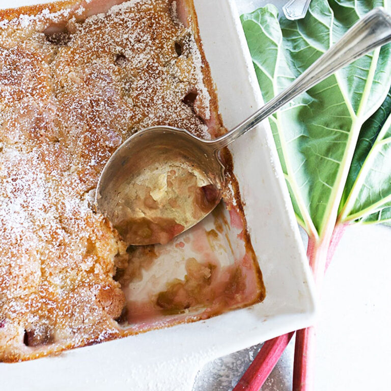 rhubarb pudding cake in pan with spoon