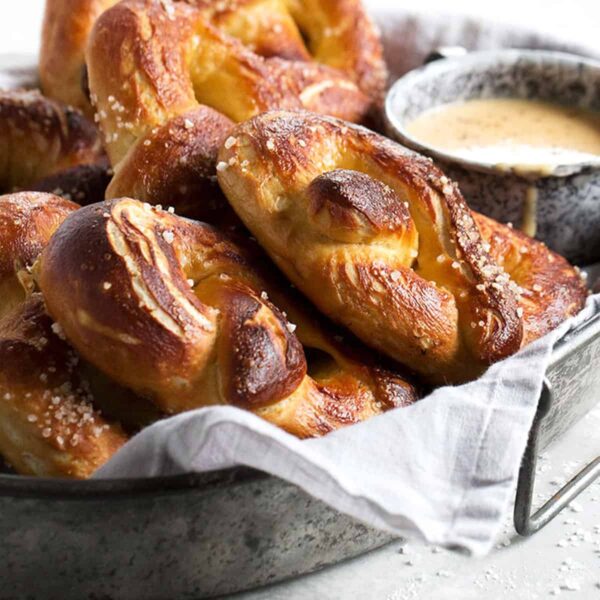 soft pretzels on tray with a cup of beer cheese