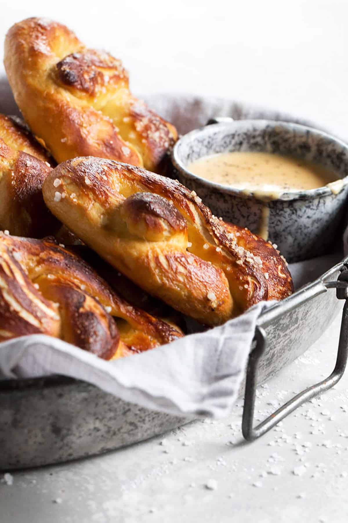 soft pretzels on tray with a cup of beer cheese