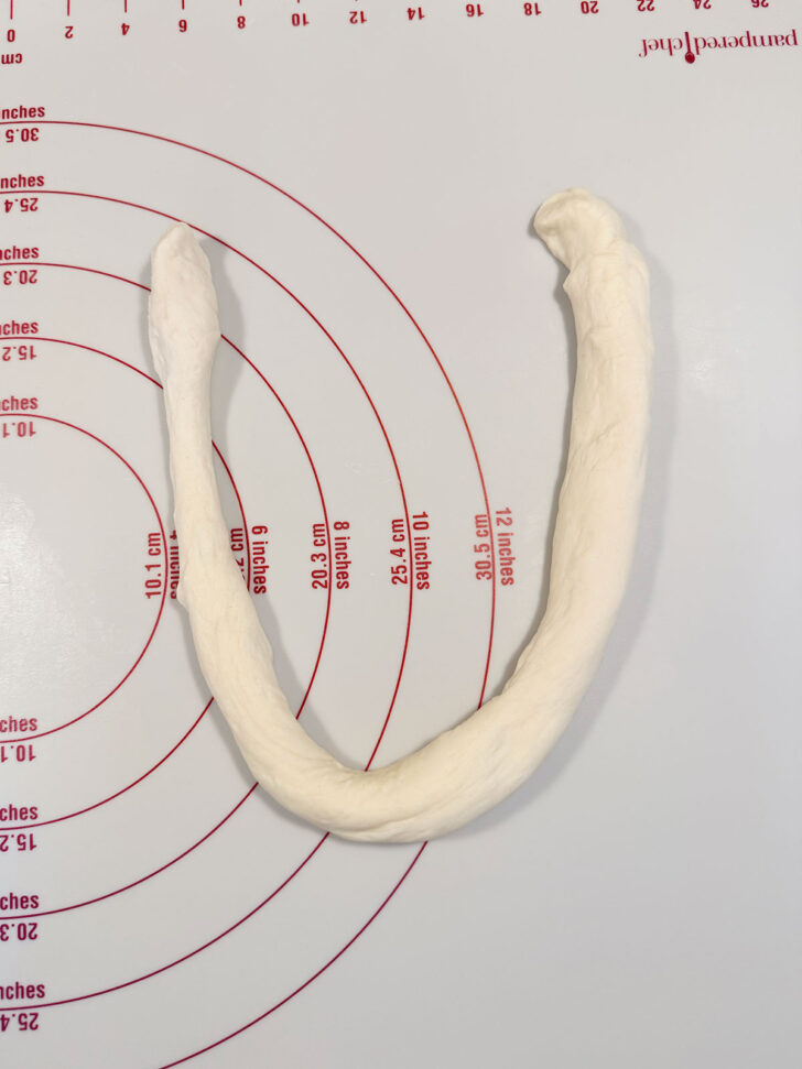 Dough rope shaped into a U shape.