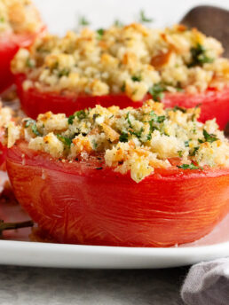 Goat cheese stuffed baked tomatoes topped with bread crumbs.
