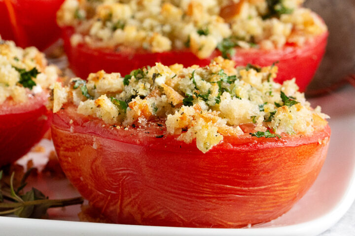 Goat cheese stuffed baked tomatoes topped with bread crumbs.