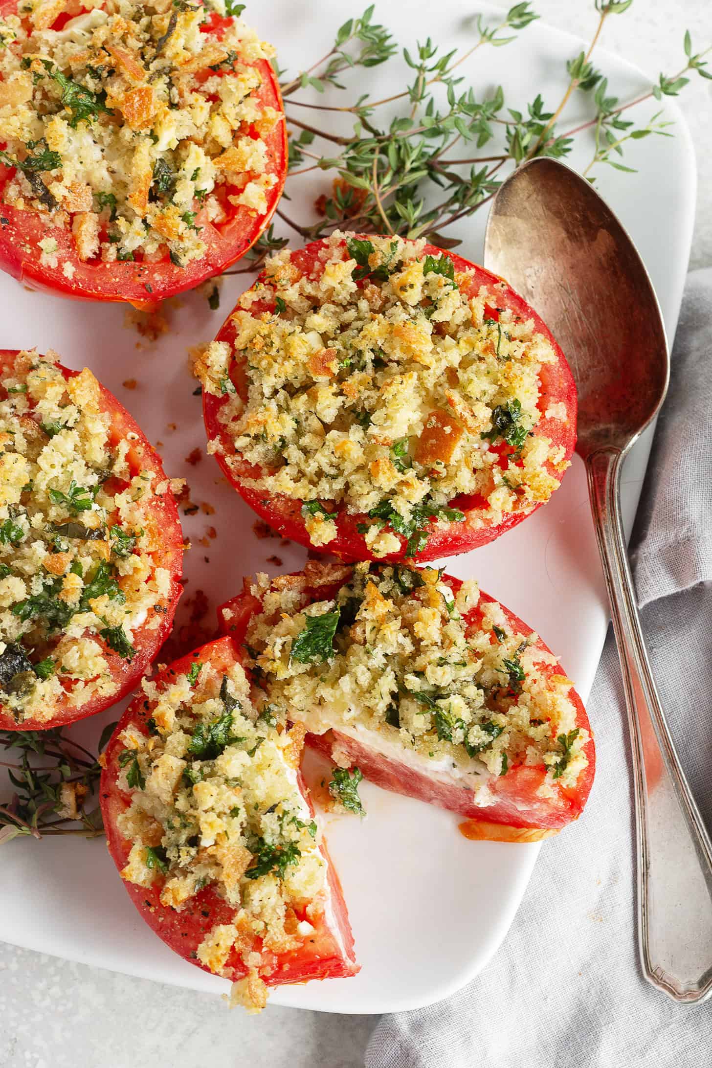 Goat cheese stuffed baked tomatoes topped with bread crumbs.