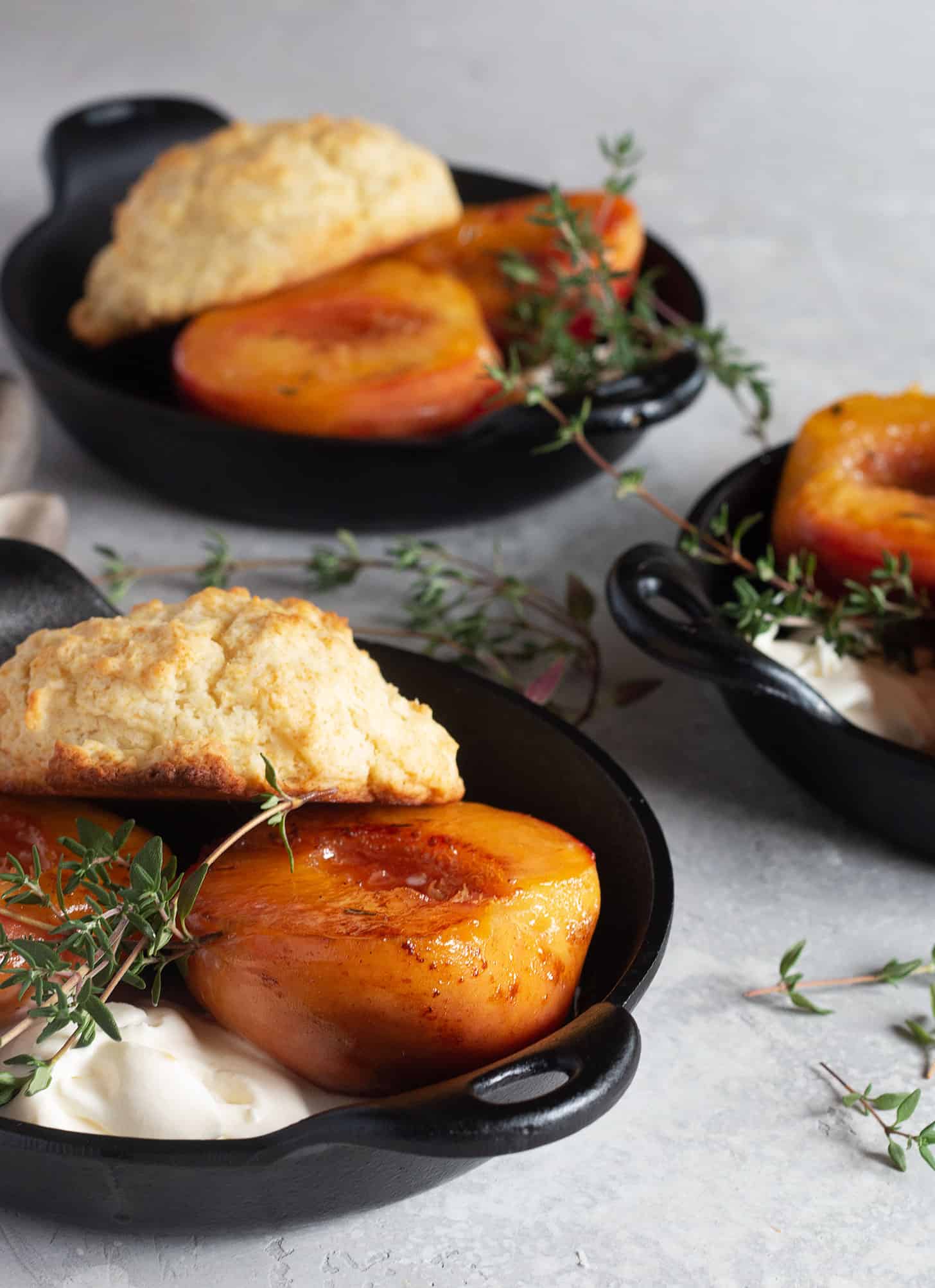 maple glazed peaches in dishes with biscuits