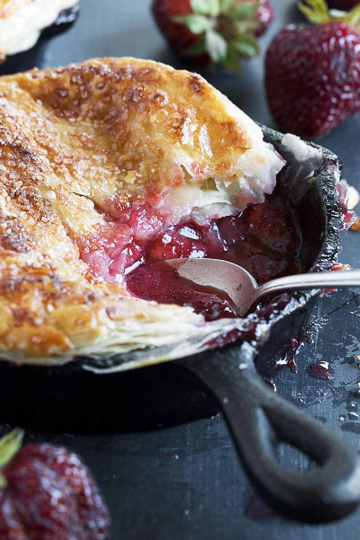 strawberry pot pie in small cast iron skillet with spoon