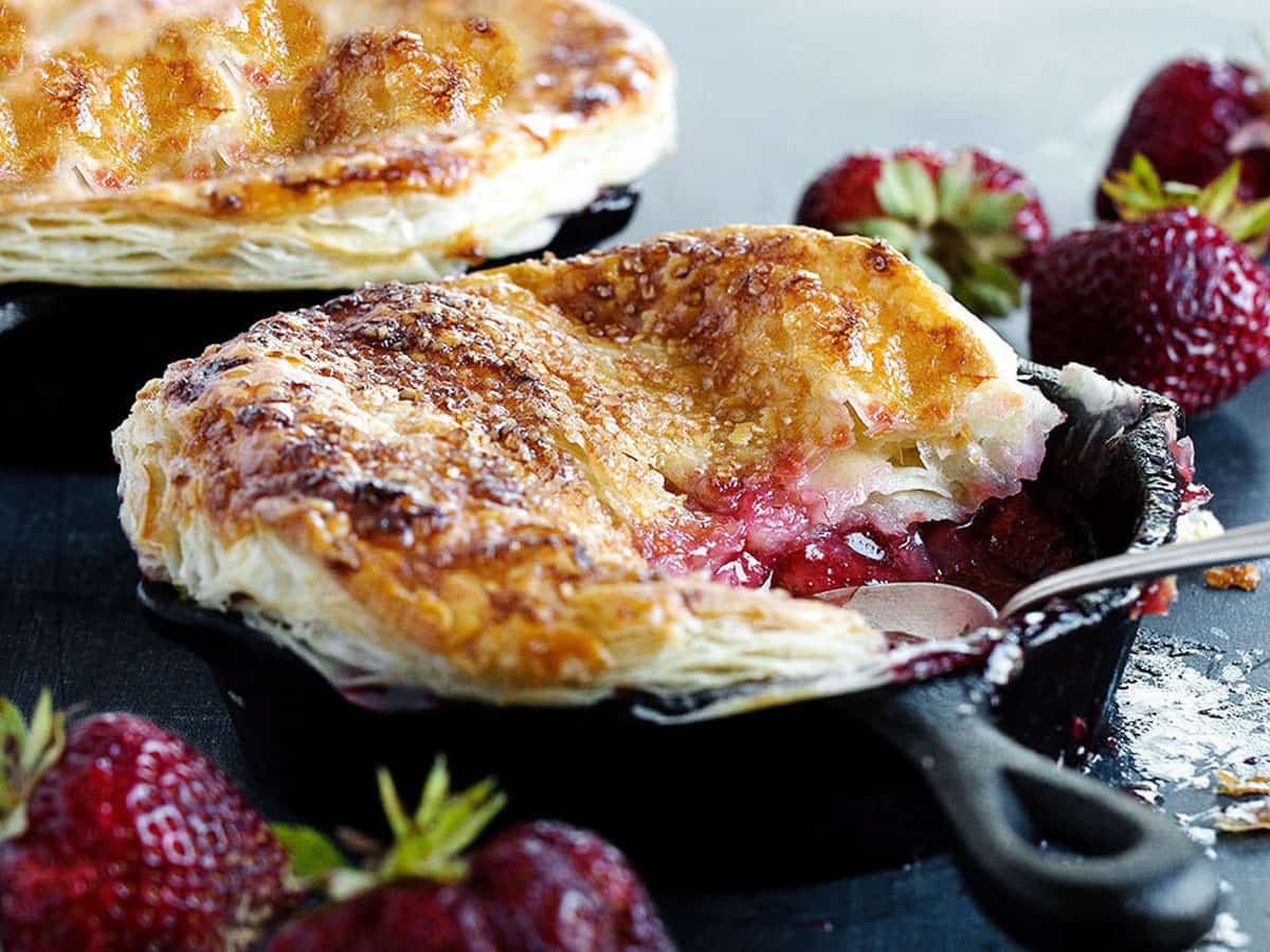 strawberry pot pie in small cast iron skillet with spoon