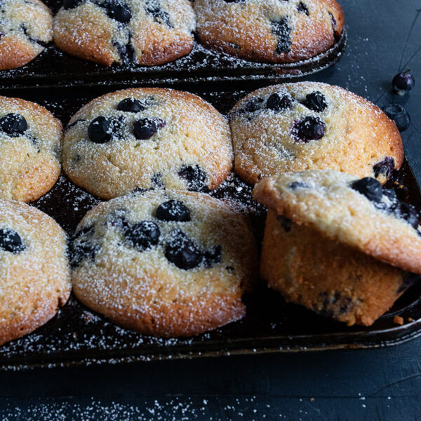 blueberry lemon muffins in muffin tin
