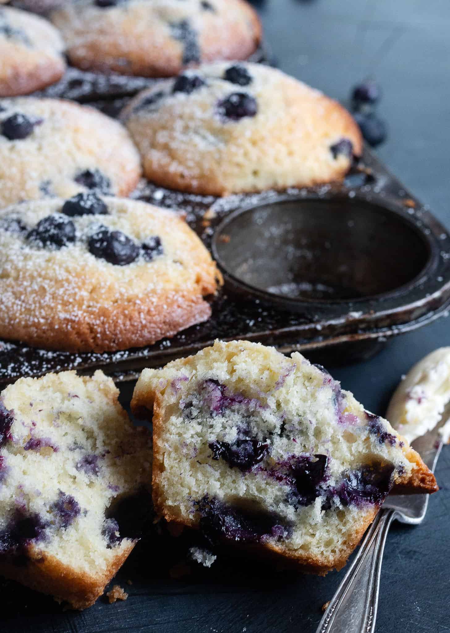 blueberry lemon muffins in muffin tins and sliced