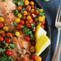 rainbow trout with mini cherry tomatoes in skillet
