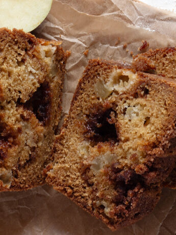 apple cinnamon loaf sliced on parchment paper