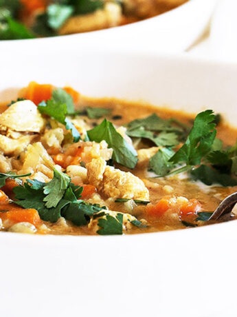 chicken mulligatawny soup in bowl with spoon