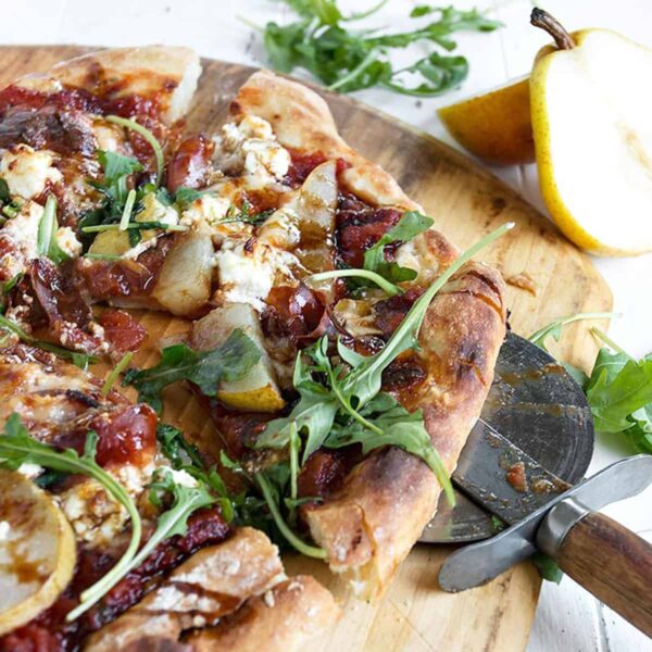 pear prosciutto pizza on pizza peel