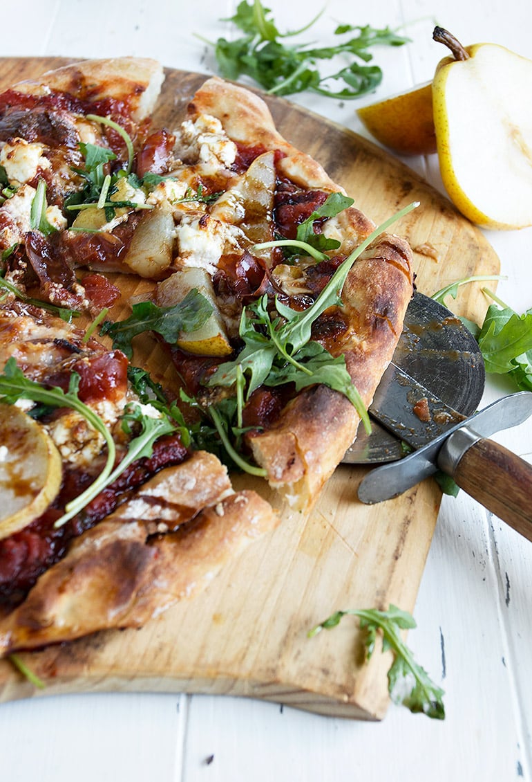 pear prosciutto pizza on a pizza peel