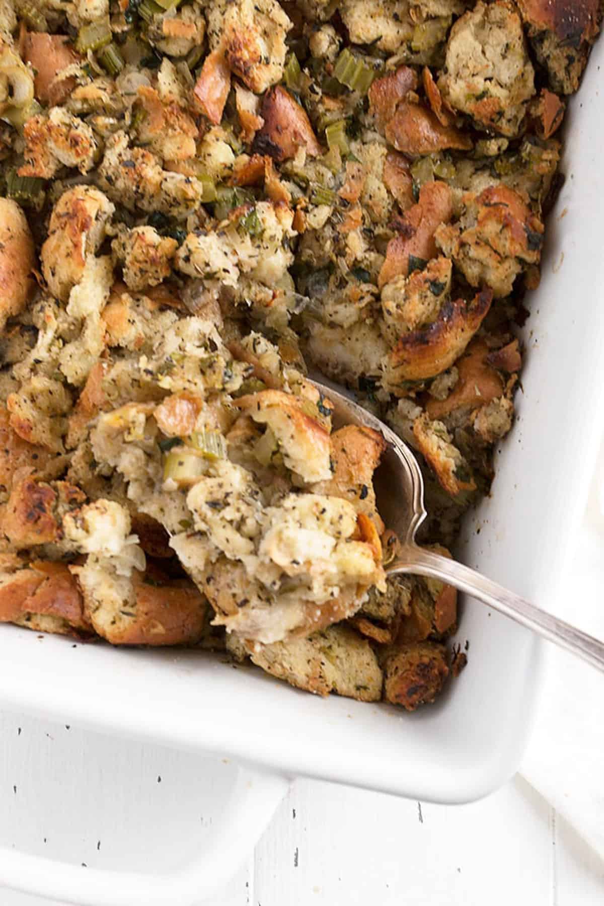 classic bread stuffing in casserole with spoon