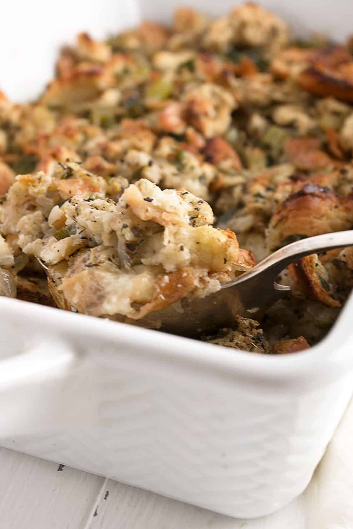 classic bread stuffing in casserole with spoon