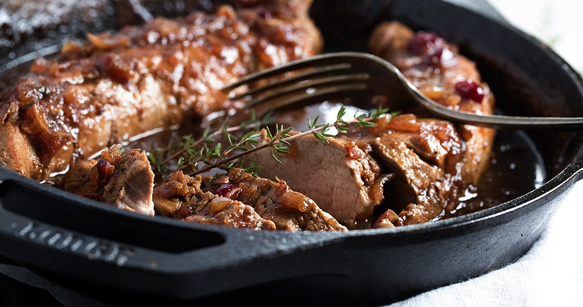 cranberry balsamic pork tenderloin in cast iron skillet