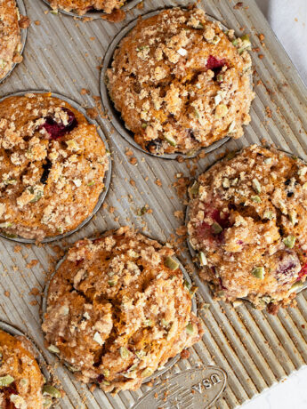 cranberry pumpkin muffins in muffin tin