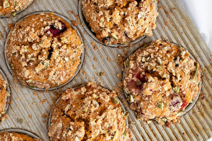 cranberry pumpkin muffins in muffin tin