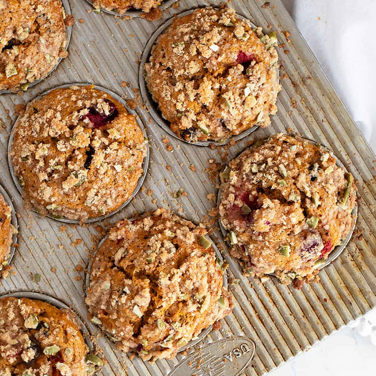 cranberry pumpkin muffins in muffin tin