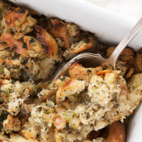 classic bread stuffing in casserole with spoon
