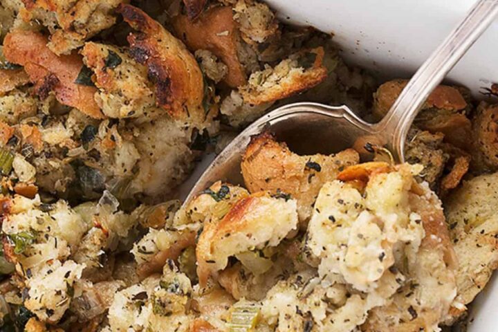 classic bread stuffing in casserole with spoon