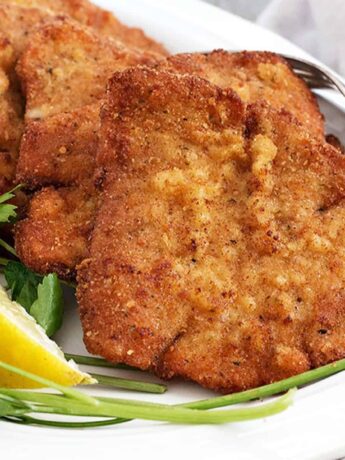 pork schnitzel on plate with lemon slices