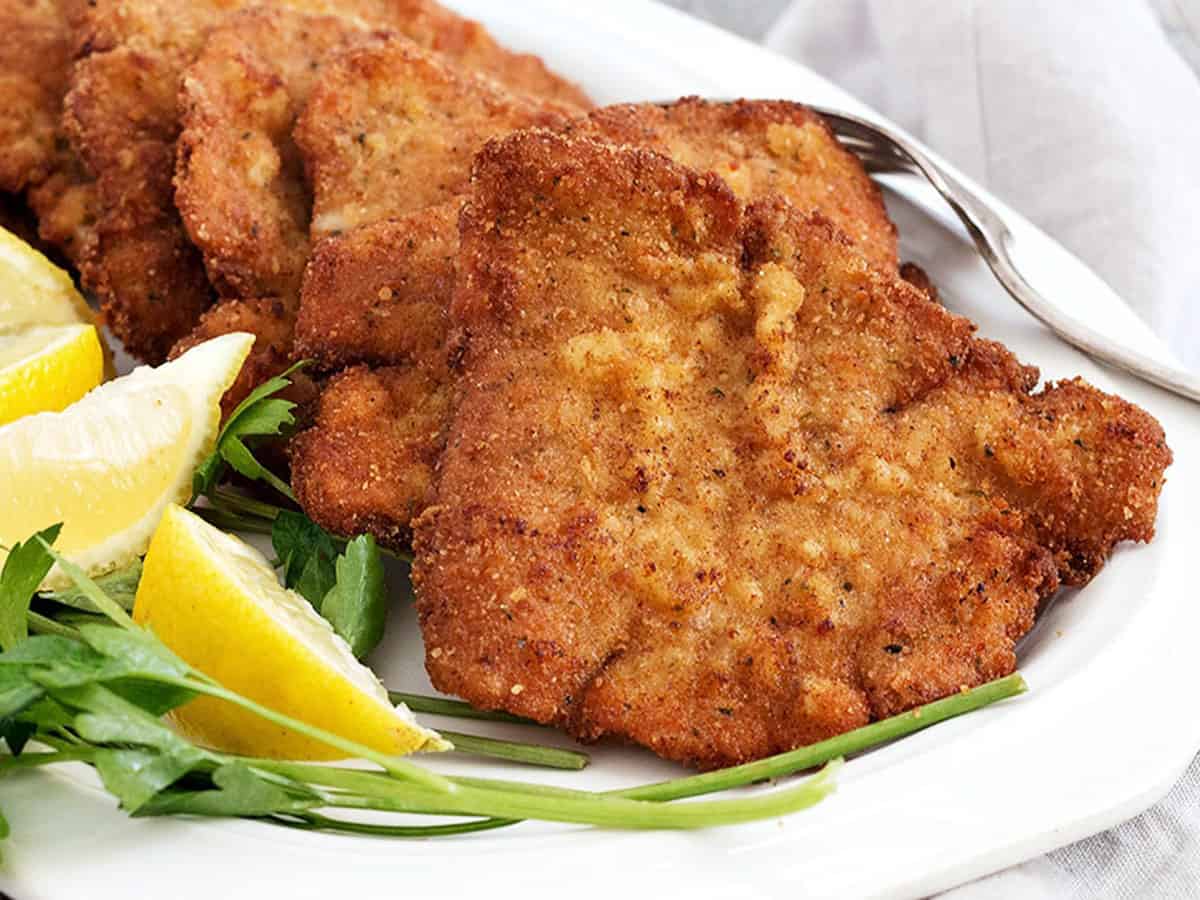 pork schnitzel on plate with lemon slices