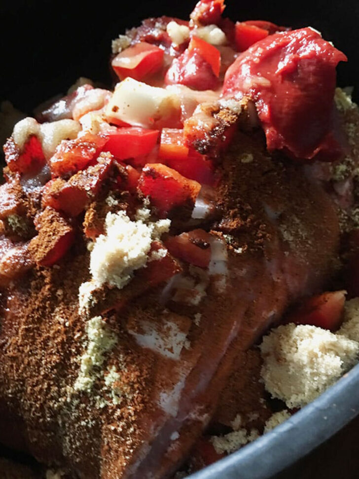 Slow cooker pulled pork ingredients in the slow cooker before cooking.