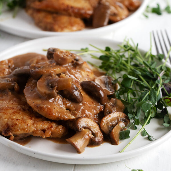 Chicken Marsala plated with greens.