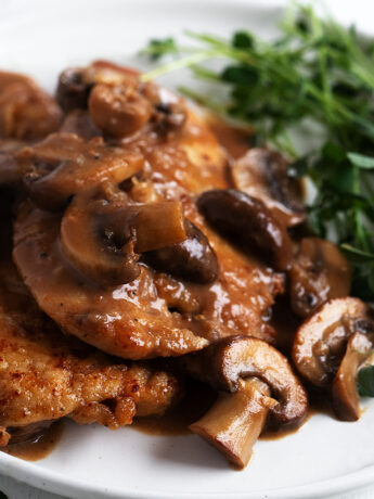 classic chicken marsala on plate with greens