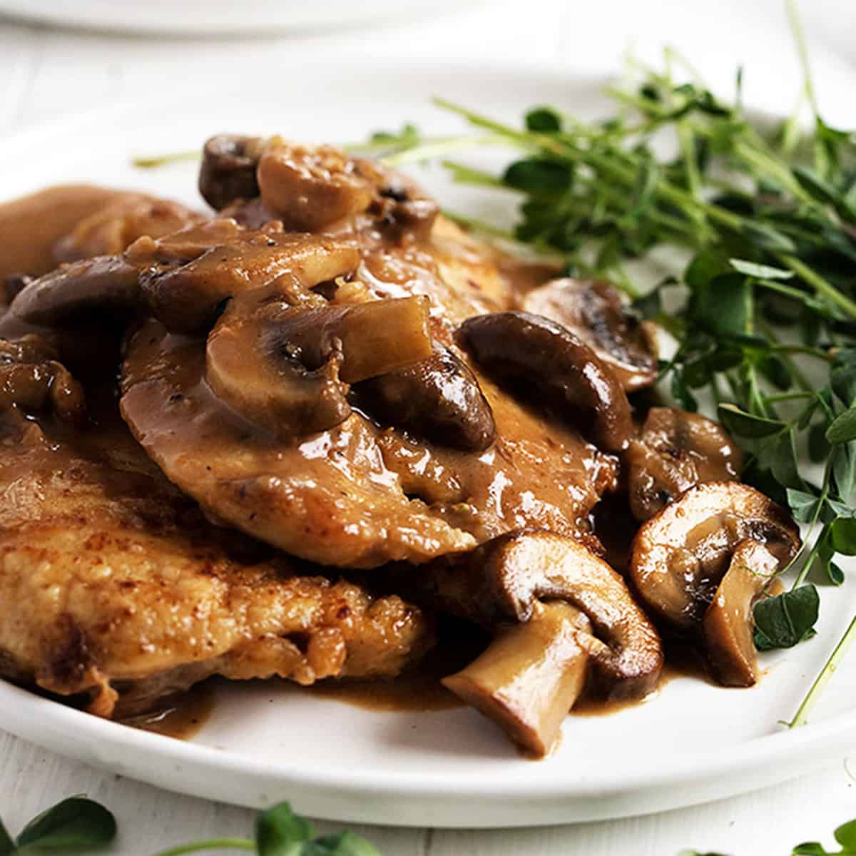 chicken marsala on plate with greens
