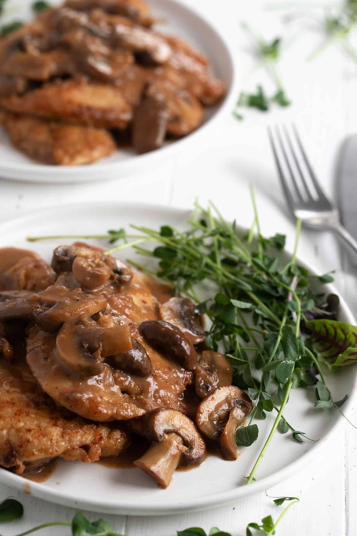 Chicken Marsala plated with greens.