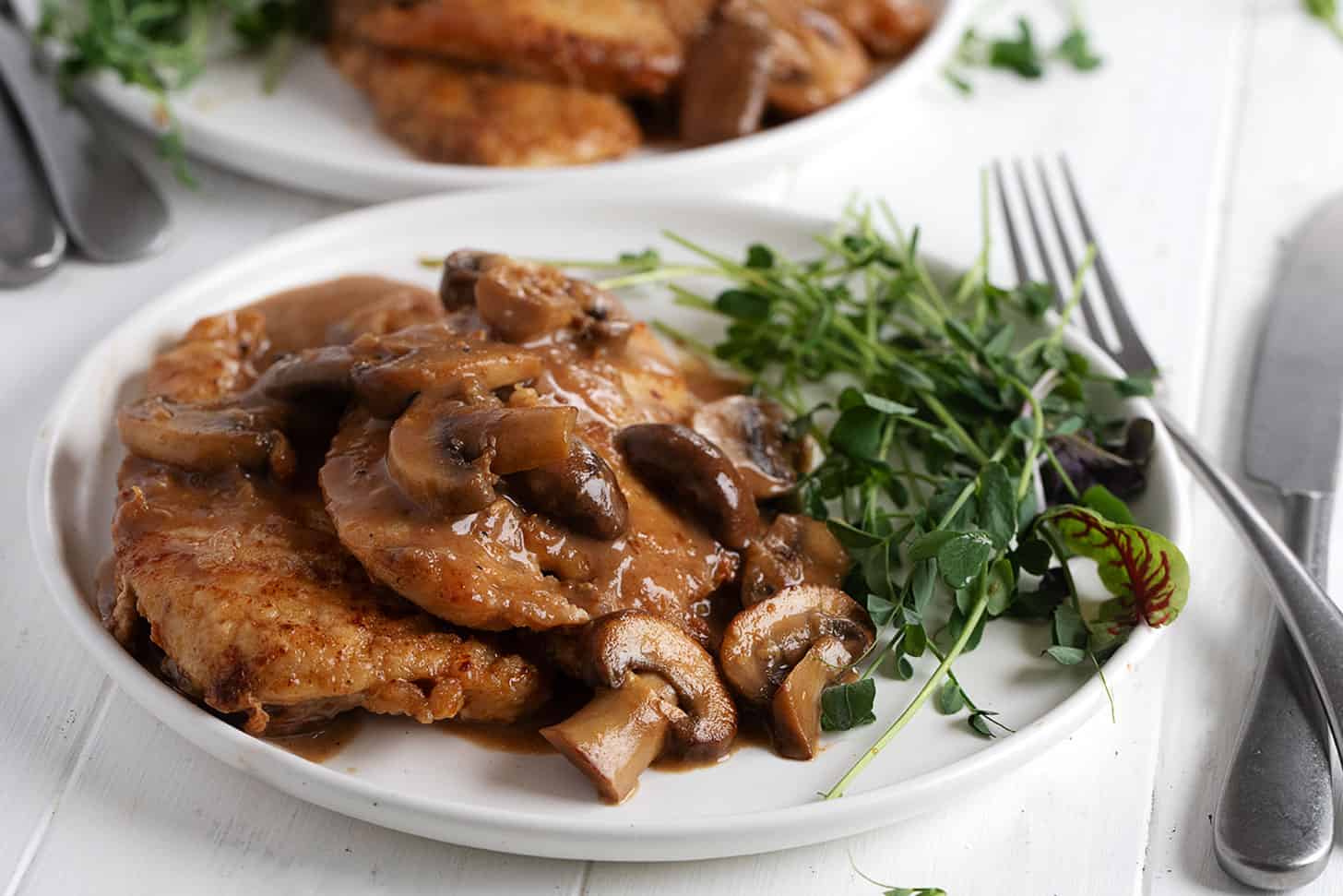 Chicken Marsala plated with greens.
