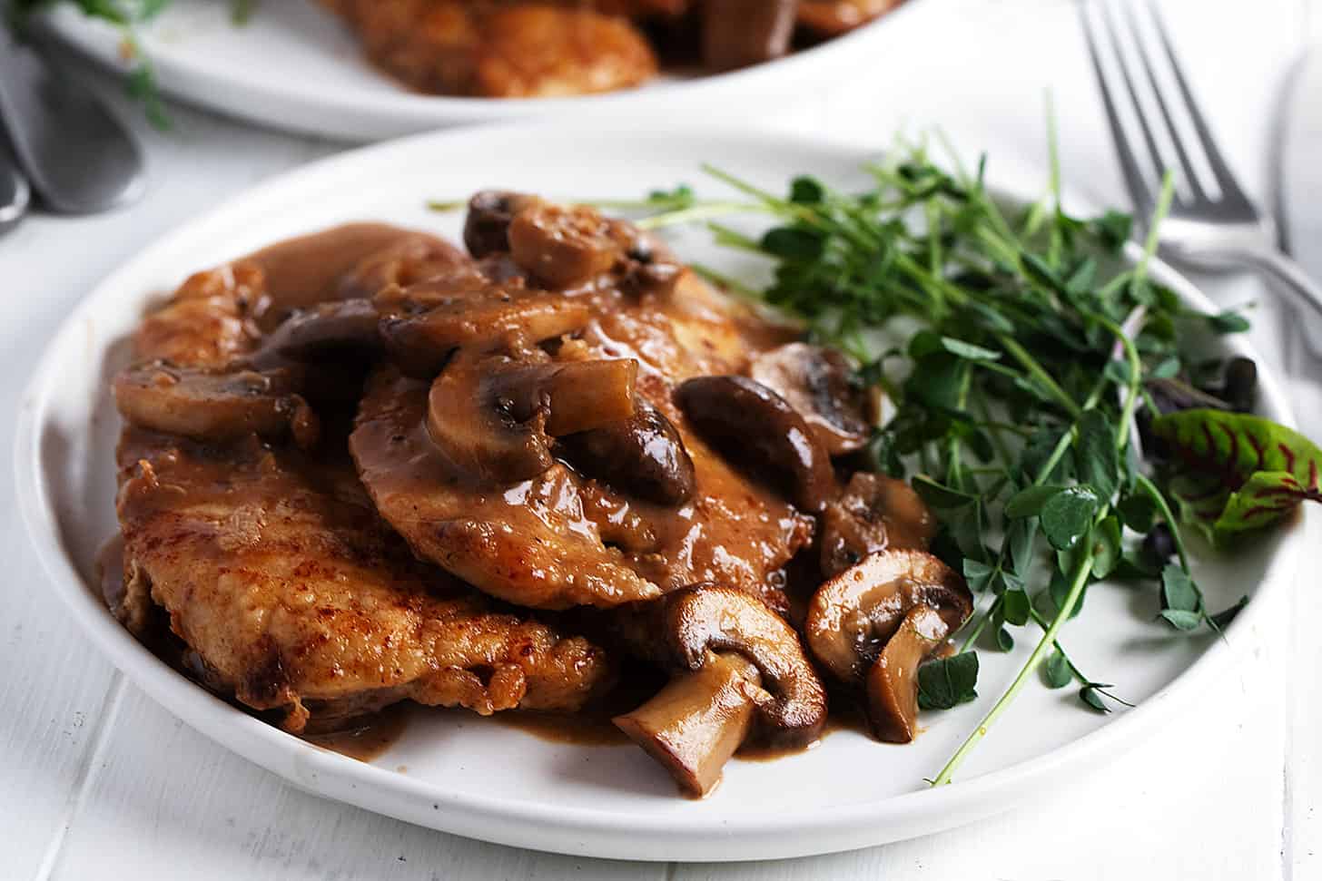 classic chicken marsala on plate with greens