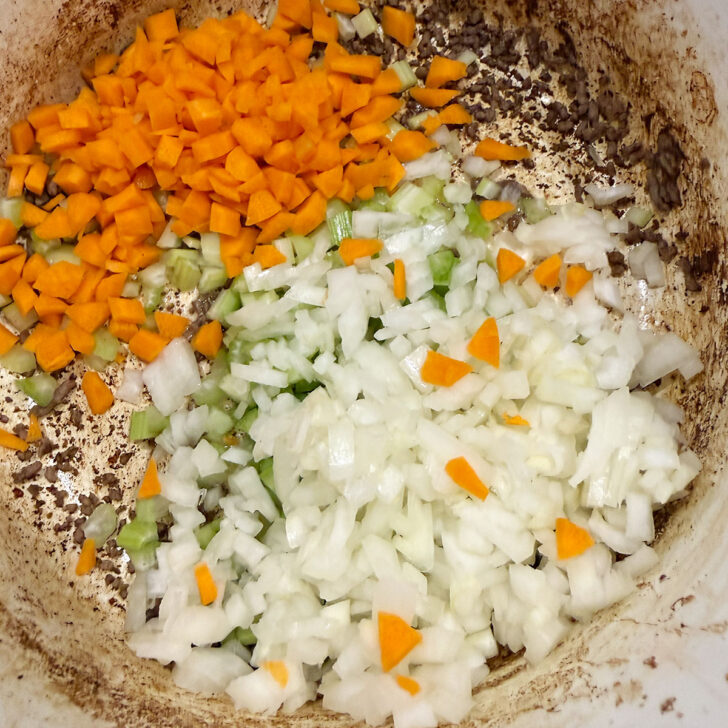 Diced onion, carrot and celery added to the pot after removing the ground beef.