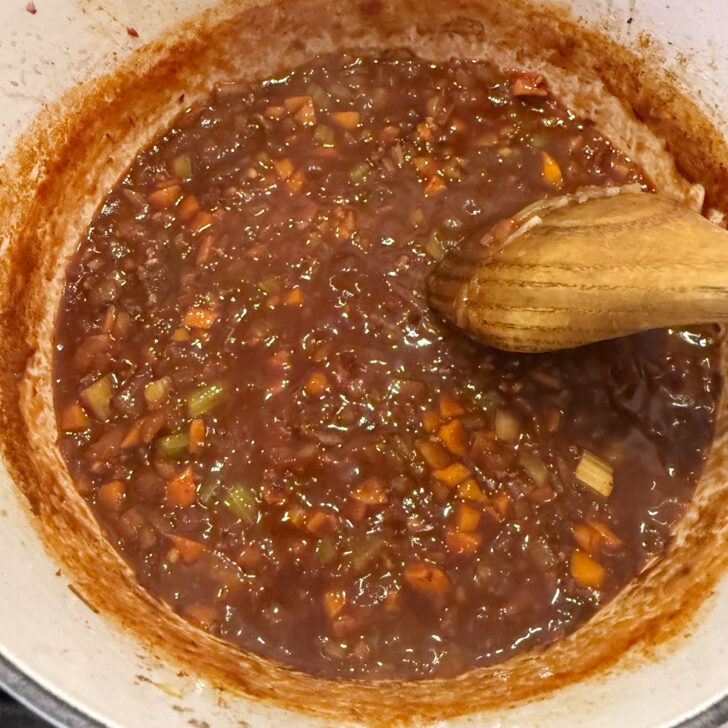 Reducing the wine in the pot.